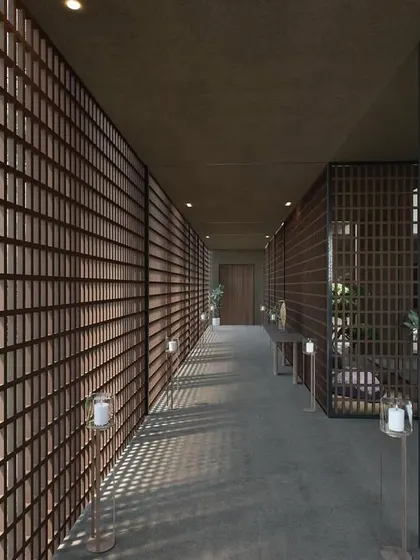 The screened corridor of The Sanctuary in Hyderabad. The entire wall is a delicate lattice of wood, creating a beautiful, rhythmic pattern of light and shadow that guides you through the space.