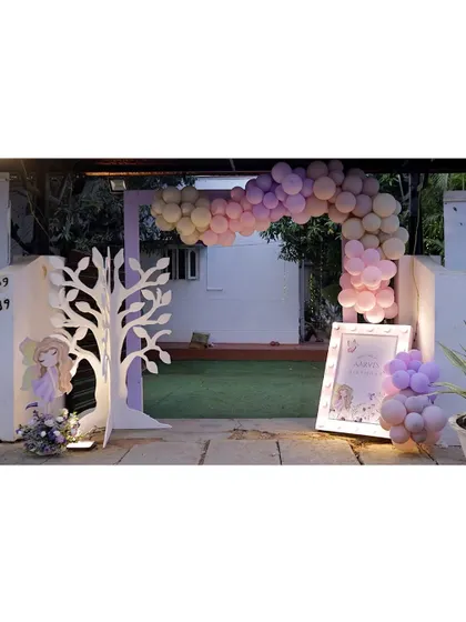 Another view of the enchanting fairy party entrance, with its purple arch, balloon garland, and illuminated welcome sign.