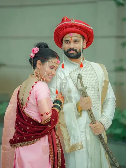 A classic portrait of the couple, showcasing their traditional attire against a simple, elegant background.