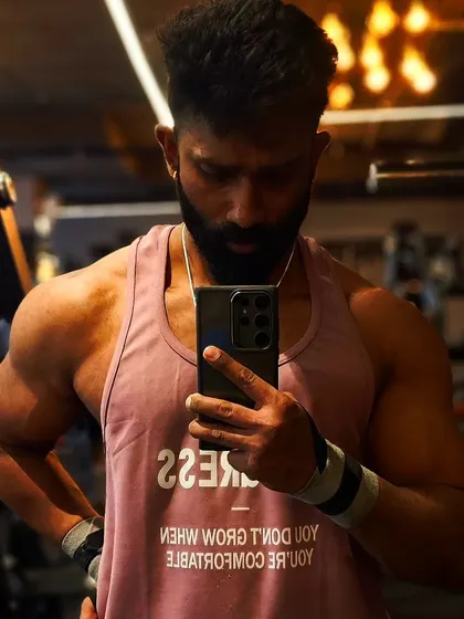 The tank top says it all: "You don't grow when you're comfortable." My philosophy is about pushing past your perceived limits to unlock real progress.