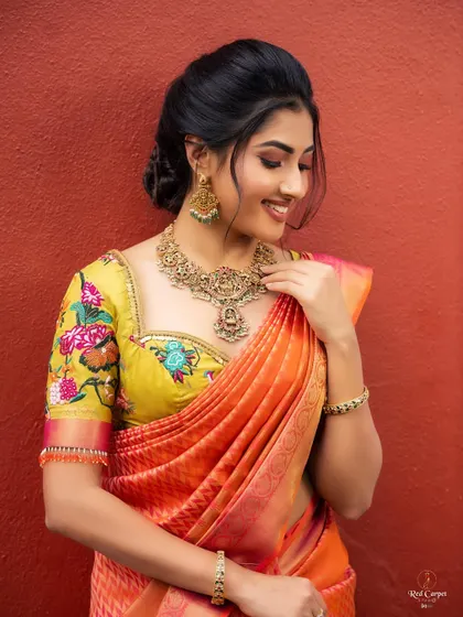A smiling, candid shot of Ragini. The vibrant colors of her outfit perfectly match her joyful energy.