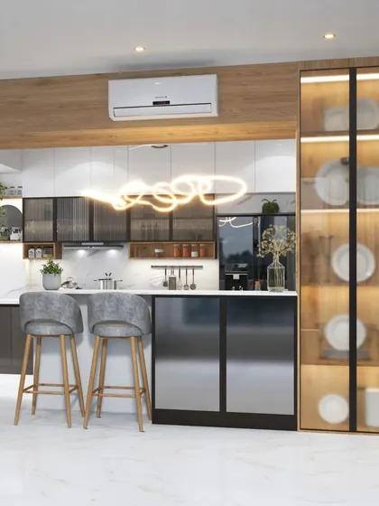 This stunning parallel kitchen features a breakfast bar, sleek gray cabinets, and a lit-up glass crockery unit. The design is perfect for open-plan living, blending the kitchen seamlessly with the dining area.