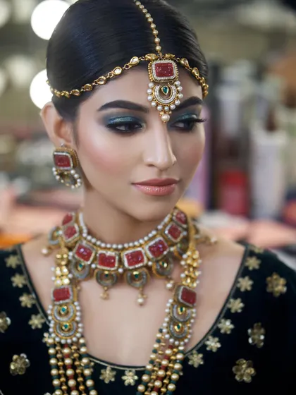 A portrait of the bride, showcasing how the dramatic eye makeup enhances her features and complements her traditional attire.