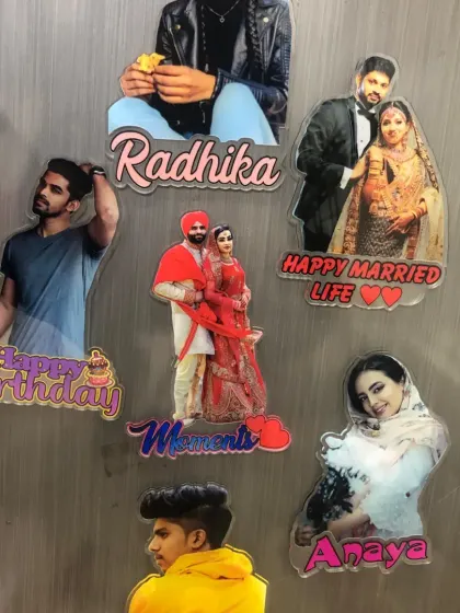 A collection of our acrylic fridge magnets, showing various custom shapes and text for birthdays, weddings, and names.