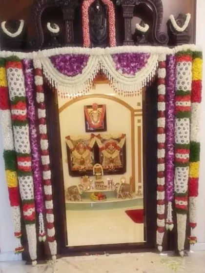 A highly customized pooja room decoration with intricate flower work. The patterns and colors are chosen to match the home's interior and the family's preferences.