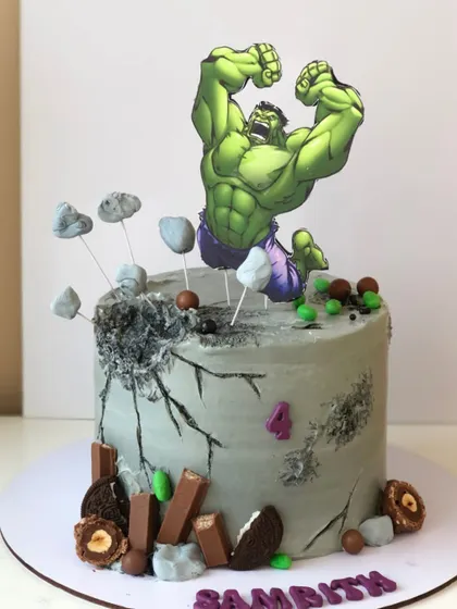 Hulk smash! This cake features the Incredible Hulk breaking through a concrete-textured buttercream cake.