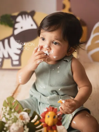 Getting right into it. This close-up captures the messy, delicious fun of a first birthday cake smash.