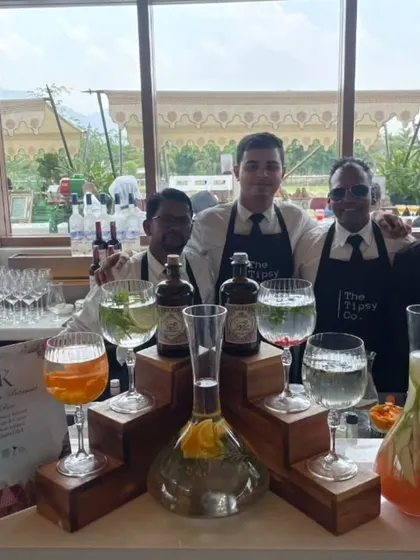 Our professional bartending crew posing at a stunning venue. We are ready to craft bespoke gin and tonics and other signature cocktails for the celebration.