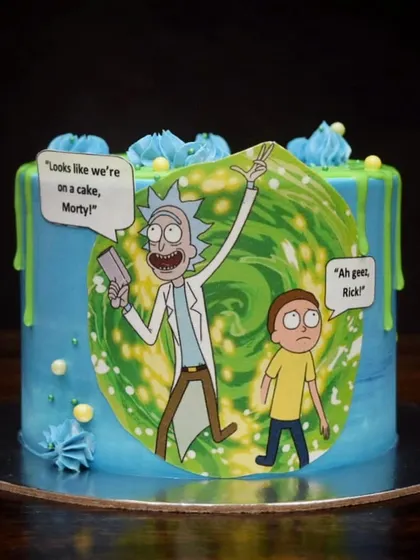 "Looks like we're on a cake, Morty!" This Rick and Morty cake features an edible print of the iconic duo jumping through a portal, set against a blue and green buttercream design with a slimy green drip.