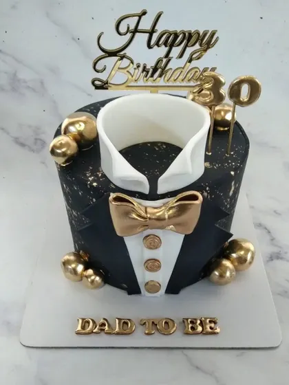 A dapper cake for a "Dad to be." This tuxedo cake is a fun and elegant way to celebrate a father-to-be's 30th birthday.