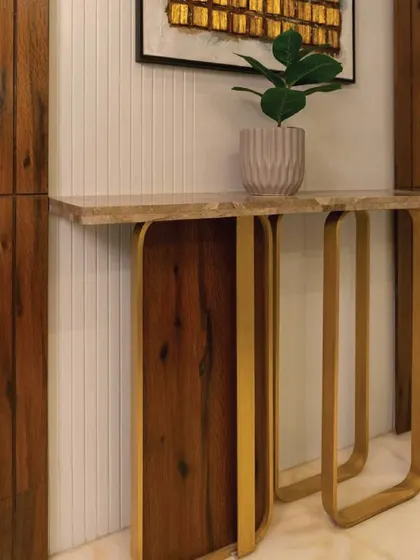 This bespoke console table showcases my love for experimental forms. The curved wooden legs and brass accents create a dynamic and artistic piece that is also highly functional.