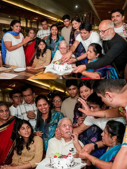 The whole family gathers to help the patriarch cut his birthday cake, followed by a playful moment of feeding him a piece. This is pure, chaotic family joy.