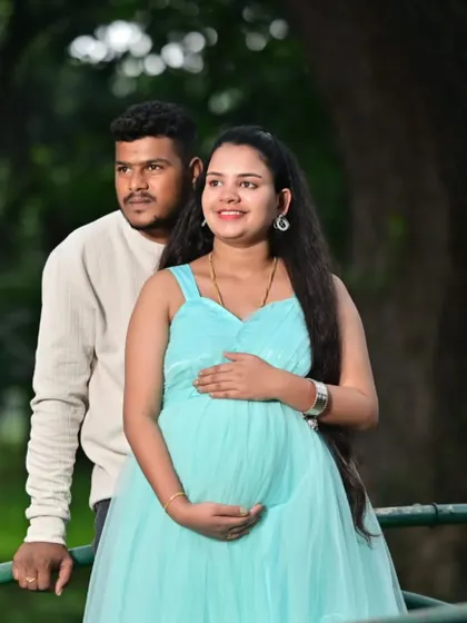 A lovely couple portrait during their maternity shoot. The light blue gown complements the natural, green surroundings perfectly, making for a serene and happy picture.