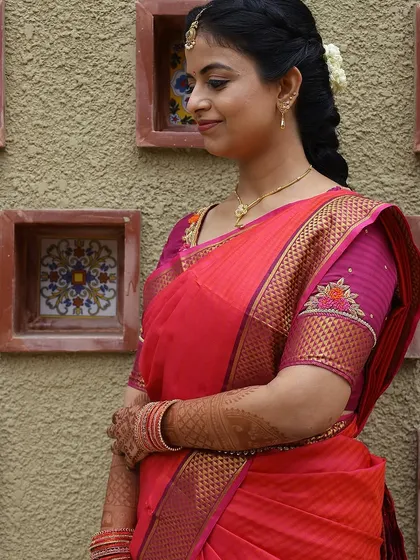 Another portrait of the bride, showcasing her graceful pose and the beautiful henna art on her hands.
