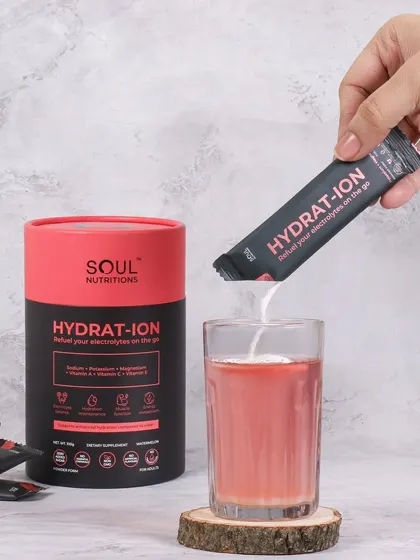 This action shot shows the hydration supplement being mixed into a glass of water. It's a simple, effective demonstration of how to use the product, making it look easy and convenient.