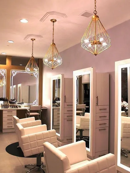 For a touch of glamour, I designed this salon with geometric pendant lights and full-length mirror stations with built-in storage. The design is both highly functional and incredibly stylish.