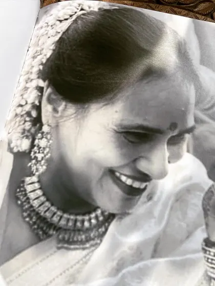 A touching black and white photograph from the Mathur Family Cookbook, capturing a moment of joy and preserving a precious memory.