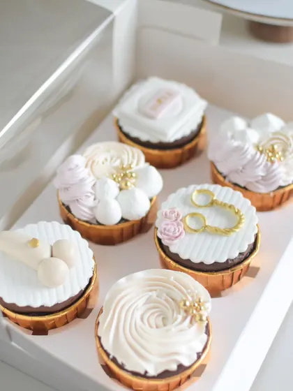 A close-up of the custom cupcakes for a bachelorette party. I created fun, themed fondant toppers to go with the Salted Caramel and Strawberry Chocolate cupcake flavors.