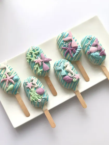My dessert tables are not complete without some matching treats. These mermaid-themed cakesicles are decorated with handcrafted tails, starfish, and shells to match the main cake.