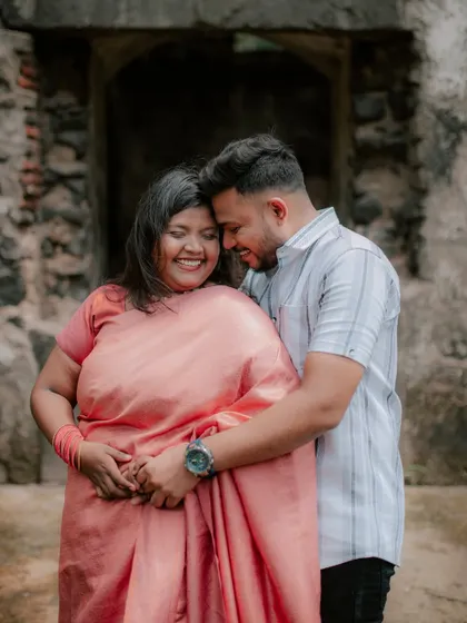 An intimate and happy embrace near historic ruins, capturing the couple's strong bond.