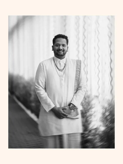 A stylish black and white portrait of the groom in his traditional wedding attire, with a creative motion blur effect that adds a dynamic feel.