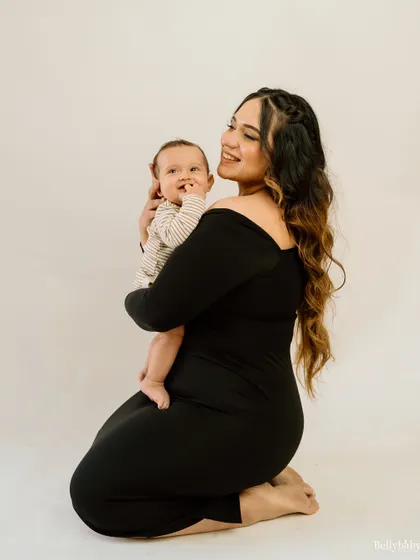 The smile that makes it all worthwhile. A simple, beautiful portrait of a mother holding her baby, radiating pure love.