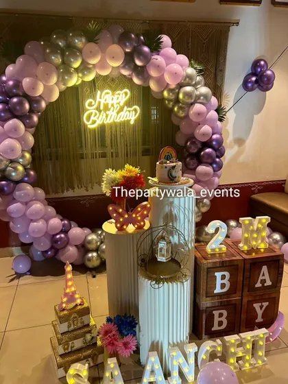 A purple, pink, and silver balloon ring with 'BABY' blocks, perfect for a 2-month celebration.
