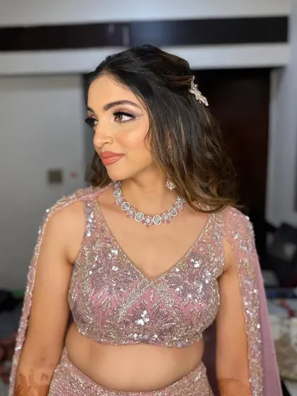 This side profile highlights the soft contour and the pretty hair accessory that completes the look.