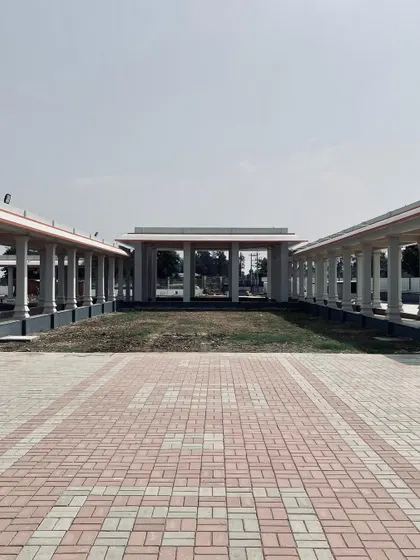 A view across one of the open courtyards, framed by pillared walkways. These unbuilt spaces are as important as the buildings themselves for creating a sense of peace.