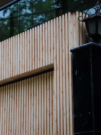 The Gate Flute, in a MetaWood finish, reimagines the entrance as a statement of understated luxury. The vertical lines of the wood-finish panels create an elegant and inviting entryway.