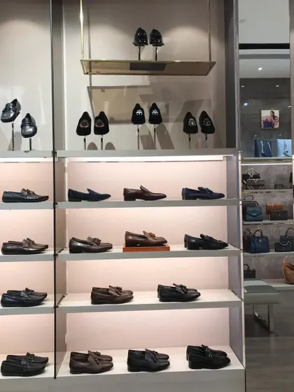 Another view of the men's shoe section, showing how mirrors are used to make the space feel larger.