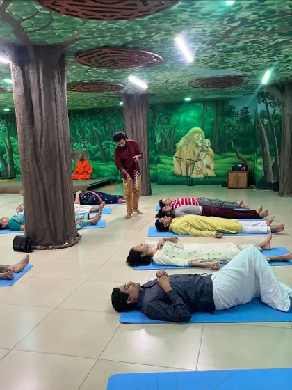 I move around the room during a sound bath to ensure everyone receives the healing vibrations. Here, I am using a Koshi chime to create a gentle, ethereal sound over the resting participants.