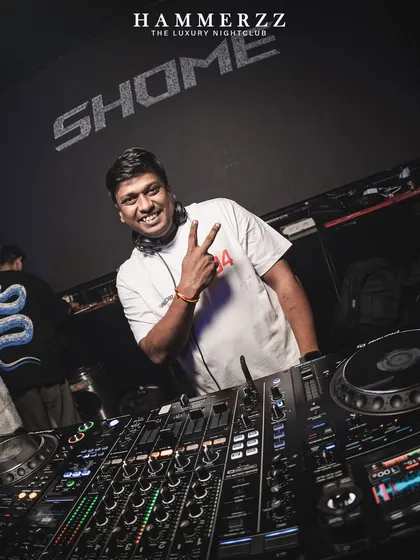 Peace and good vibes from the DJ booth. A quick pose for the camera while keeping the party going at Hammerzz.