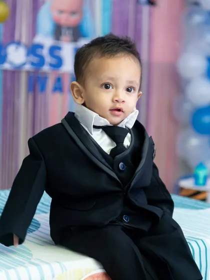 Another angle from our "Boss Baby" themed session, this portrait shows the little one looking curious and charming in his formal birthday attire.
