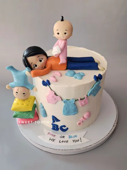 Before the actual fun begins! A funny and cute baby shower cake showing a mom juggling her little ones. A chocolate truffle cake for a mom-to-be with a great sense of humor.