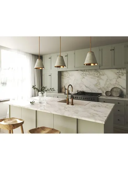 A closer look at a custom kitchen island with a stunning marble countertop. We designed this space with sage green shaker-style cabinets and elegant pendant lighting, blending classic and modern aesthetics for a timeless look.