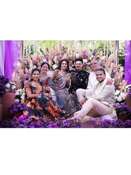 A lovely family portrait from a vibrant, purple-themed pre-wedding celebration.