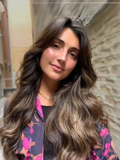 Soft, sun-kissed highlights on long, wavy hair. This look is part of our Autumn Shades collection, perfect for adding warmth and dimension as the seasons change.