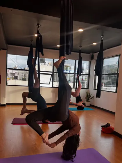 An inverted pose in the hammock, which helps to decompress the spine and improve blood flow to the brain.