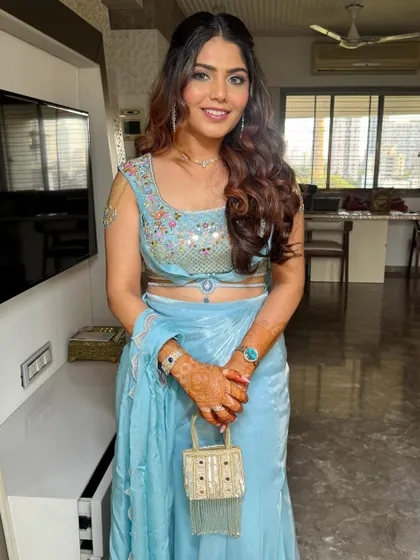A classic front view of the finished hairstyle. The balance of the half-up style and the flowing curls creates a look that is both elegant and festive.
