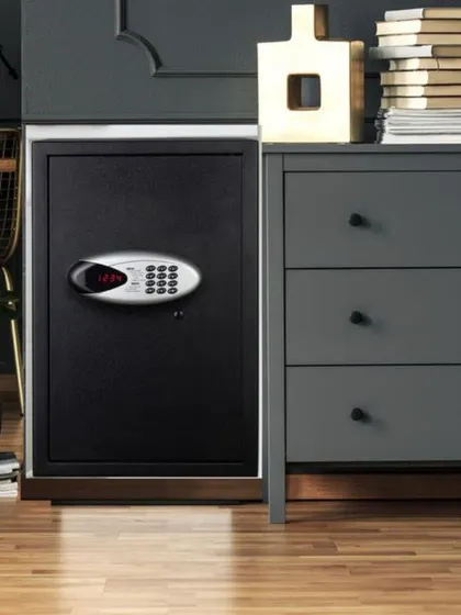 Here, the Safilo Digital-2 safe is shown discreetly placed in an office or home setting. Its sleek black design and scratch-resistant powder coating allow it to blend seamlessly with modern interiors while providing robust security.