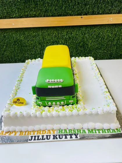 A massive 5kg sculpted cake of a green and yellow cargo truck, perfect for a transportation-loving birthday boy.