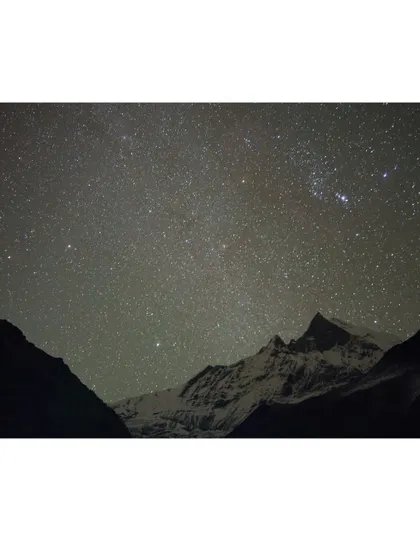 A starry night sky over the Annapurna range. Camping in the Himalayas offers incredible opportunities for astrophotography and stargazing, far from city lights.