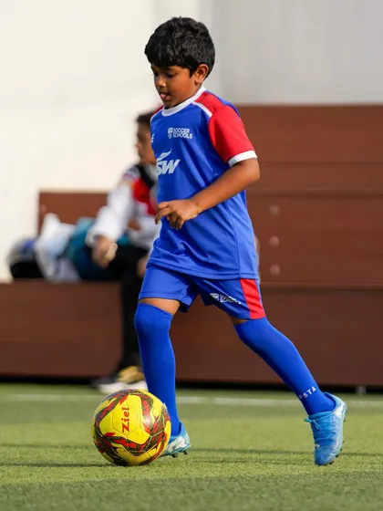 A young footballer confidently moves the ball forward. Our training builds the skills and self-belief needed to control the game.