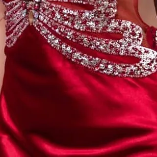 A shot focusing on the side detail and the rich red satin of the skirt, showing the quality craftsmanship.