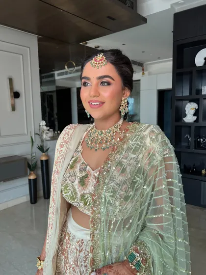 A photo of the same bride, her smile lighting up the room. The makeup is fresh and youthful.