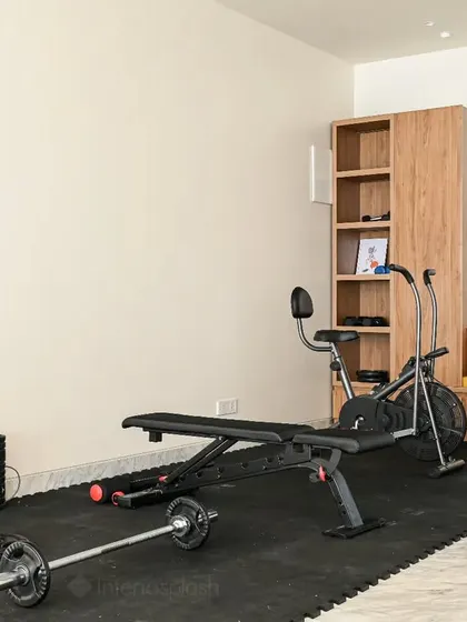 A dedicated home gym area we designed, with proper flooring and storage for equipment.