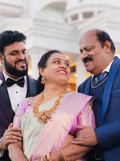 A heartwarming family portrait of the groom with his parents, capturing a moment of love and pride.