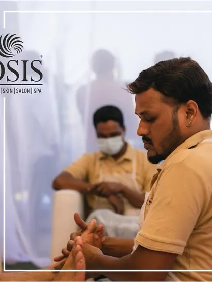 A focused shot of one of our therapists providing a foot massage at an event. We bring the same level of professionalism and care to our on-site services as we do in our spas.