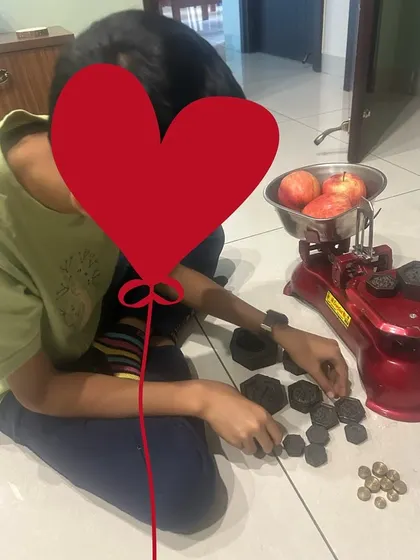 This image captures the joy of discovery. By physically placing weights on the scale, this child is developing an intuitive understanding of measurement and equivalence. It’s a far more powerful lesson than just looking at numbers on a page.